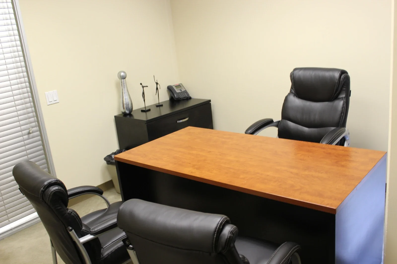 Day Office with a wood-top desk, executive chair and two upholstered guest chairs.